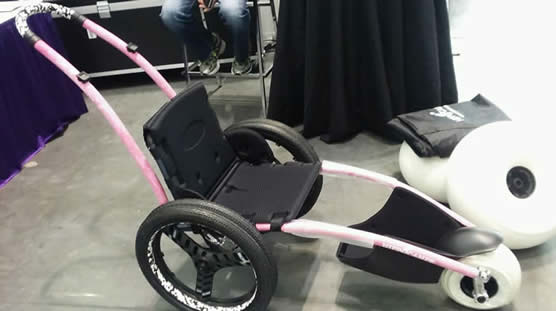 Recreation wheelchair with additional oversized beach wheels stacked nearby.